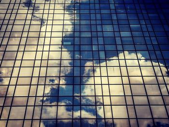 Low angle view of glass building against sky