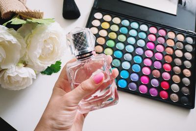 Cropped image of hand holding perfume bottle