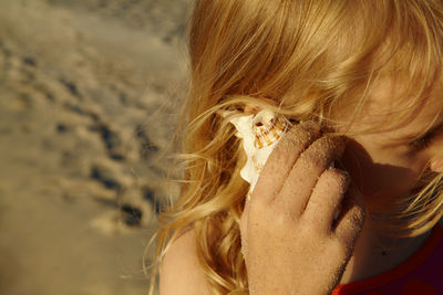 Close-up portrait of woman with hair at beach