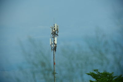 Low angle view of communications tower against sky