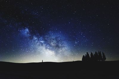 Low angle view of silhouette landscape against sky at night