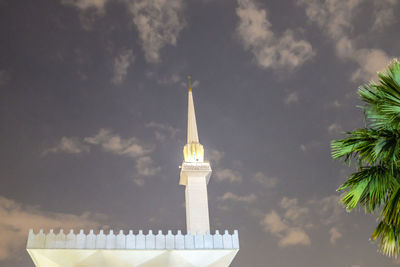 Low angle view of building against cloudy sky