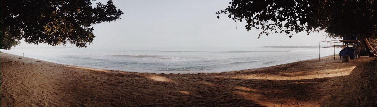 beach, sea, horizon over water, sand, water, shore, tranquility, tranquil scene, scenics, beauty in nature, nature, sky, tree, idyllic, coastline, wave, clear sky, incidental people, sunlight, remote