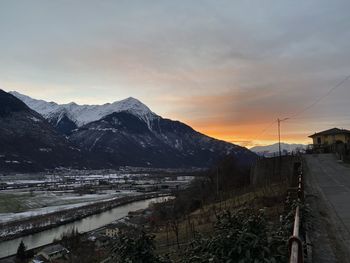 Scenic view of snowcapped mountains against sky during sunset