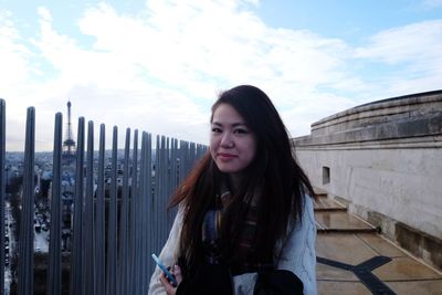 Portrait of beautiful woman against sky