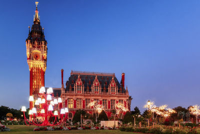 View of illuminated building against blue sky