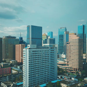 Modern buildings in city against sky