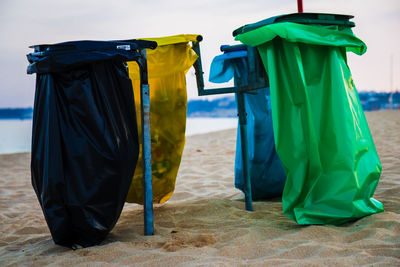 Multi colored umbrellas on beach against sky