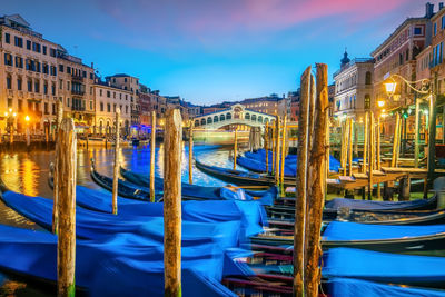 Boats moored in canal at night