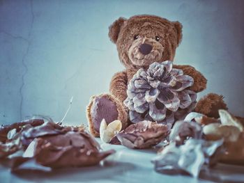 Close-up of stuffed toy on table against wall