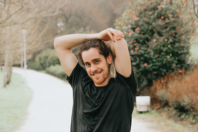 Portrait of smiling young man standing outdoors