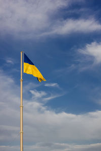 Low angle view of flag against sky