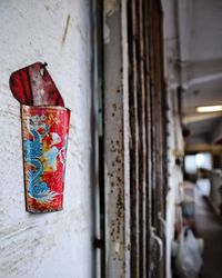 Close-up of container hanging on wall