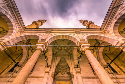 Low angle view of historical building against cloudy sky