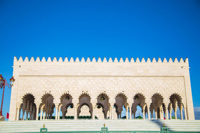 Low angle view of historical building against clear blue sky