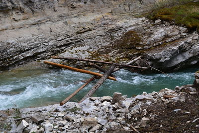 High angle view of stream flowing through rocks