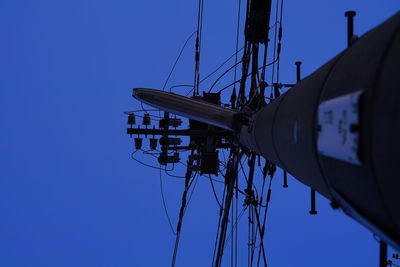 Low angle view of sailboat against clear blue sky