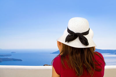 Rear view of woman looking at sea against sky