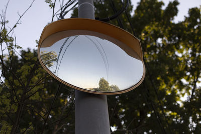 Mirror in the parking lot. spherical mirror on a pole. reflective surface on a sunny day.