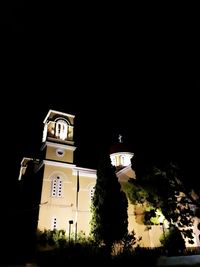 Low angle view of bell tower against sky at night