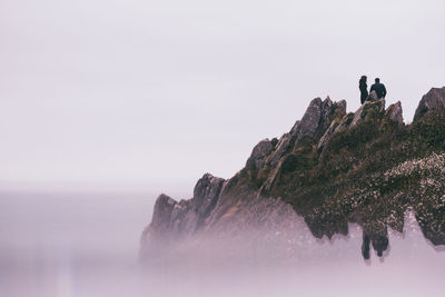 Panoramic view of rocks on mountain against clear sky