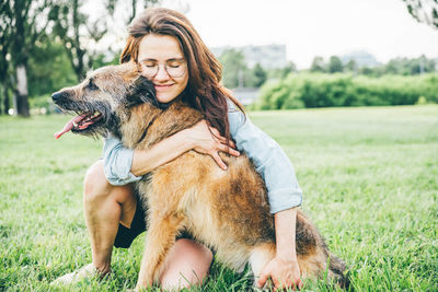 Young woman with dog on field