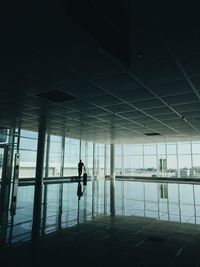 Silhouette man standing at airport 