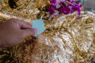 Close-up of hand holding ice cream