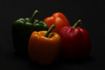 Close-up of bell peppers against black background