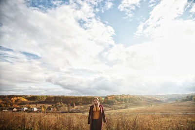 Man standing on field against sky