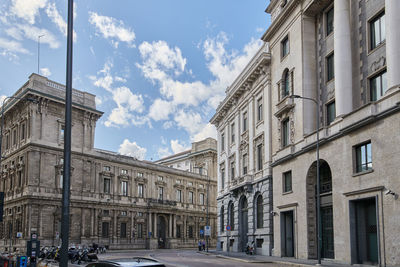 Street amidst buildings against sky in city