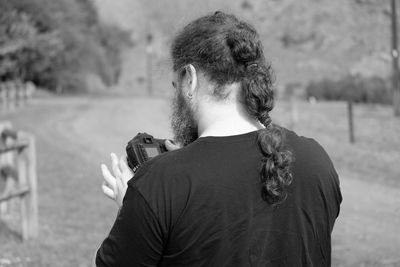 Rear view of man standing outdoors