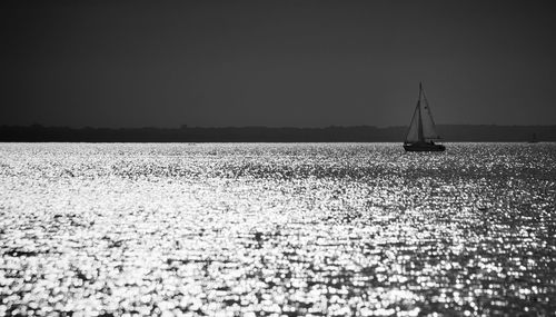 Sailboat on field against clear sky