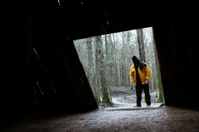 Full length of man standing in forest