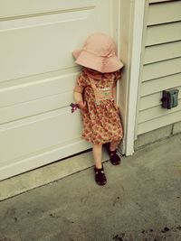 High angle view of girl standing against door