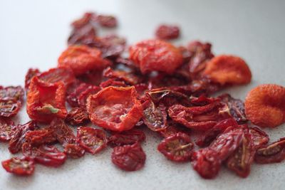 Close-up of red chili peppers over white background