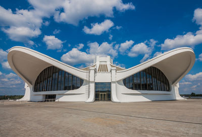 View of modern building against cloudy sky