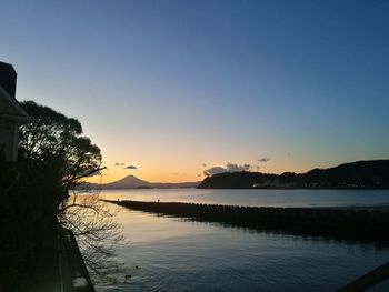 Scenic view of sea against clear sky during sunset