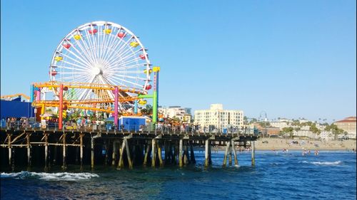 Ferris wheel against clear blue sky