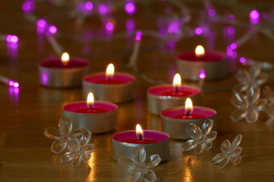 Close-up of illuminated candles on table