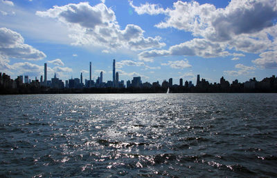 Scenic view of sea and buildings against sky