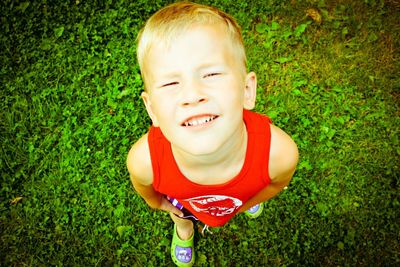 Portrait of boy playing on grassy field