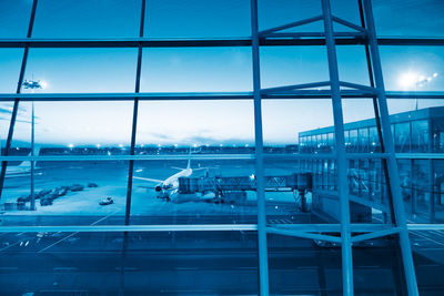 View of airport seen through glass window