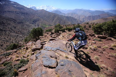 High angle view of mountain biker moving down hill