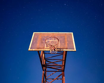Nocturnal view of basketball post hoop