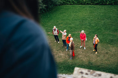 Group of people running on grassland