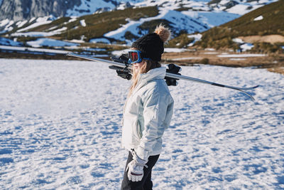 Full length of man skiing on snow covered landscape