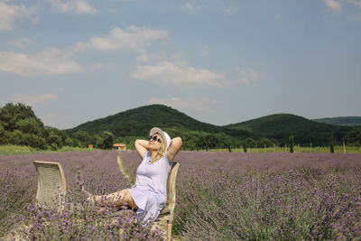 Rear view of woman standing on field