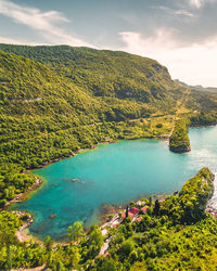 High angle view of lake and mountains against sky