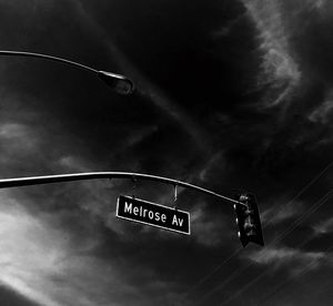 Low angle view of information sign on stoplight